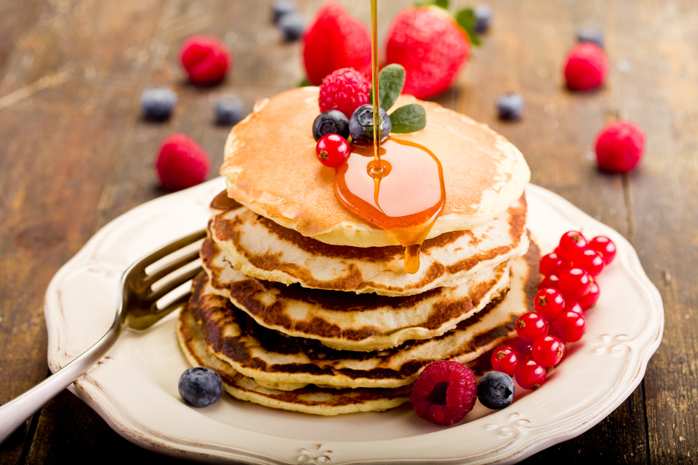 Pancake stack with berries and syrup